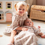Beatrice Rose Stripe nightie, child sitting on a rug beside a baby, both wearing the floral striped nightie