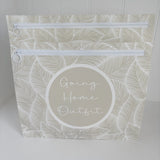 Hospital bag organiser pouches, beige leaf, a Going Home Outfit pouch in front of a larger pouch, both zips visible