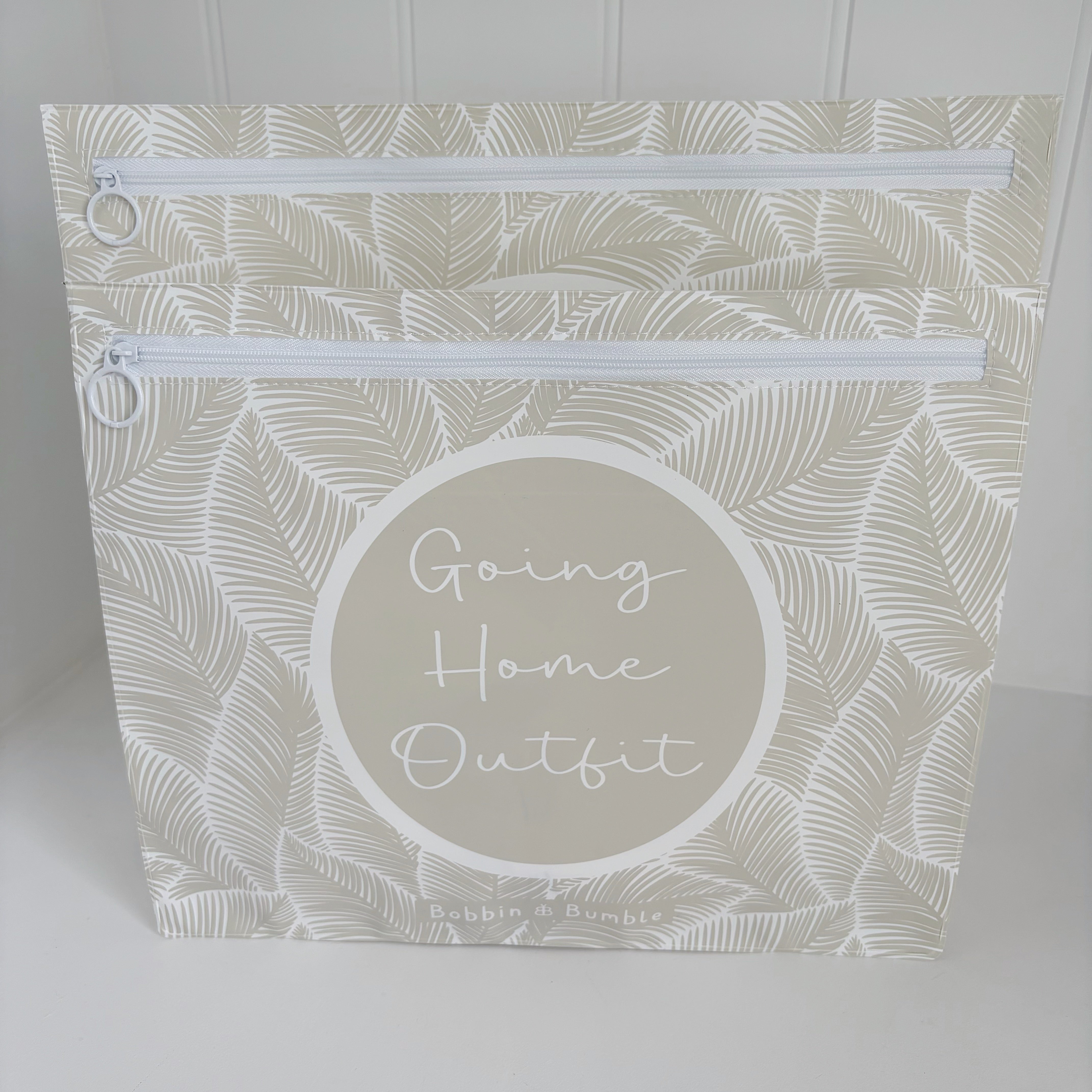 Hospital bag organiser pouches, beige leaf, a Going Home Outfit pouch in front of a larger pouch, both zips visible