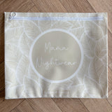 Hospital bag organiser pouches, beige leaf, flat pouch labelled Mama Nightwear on a wooden floor