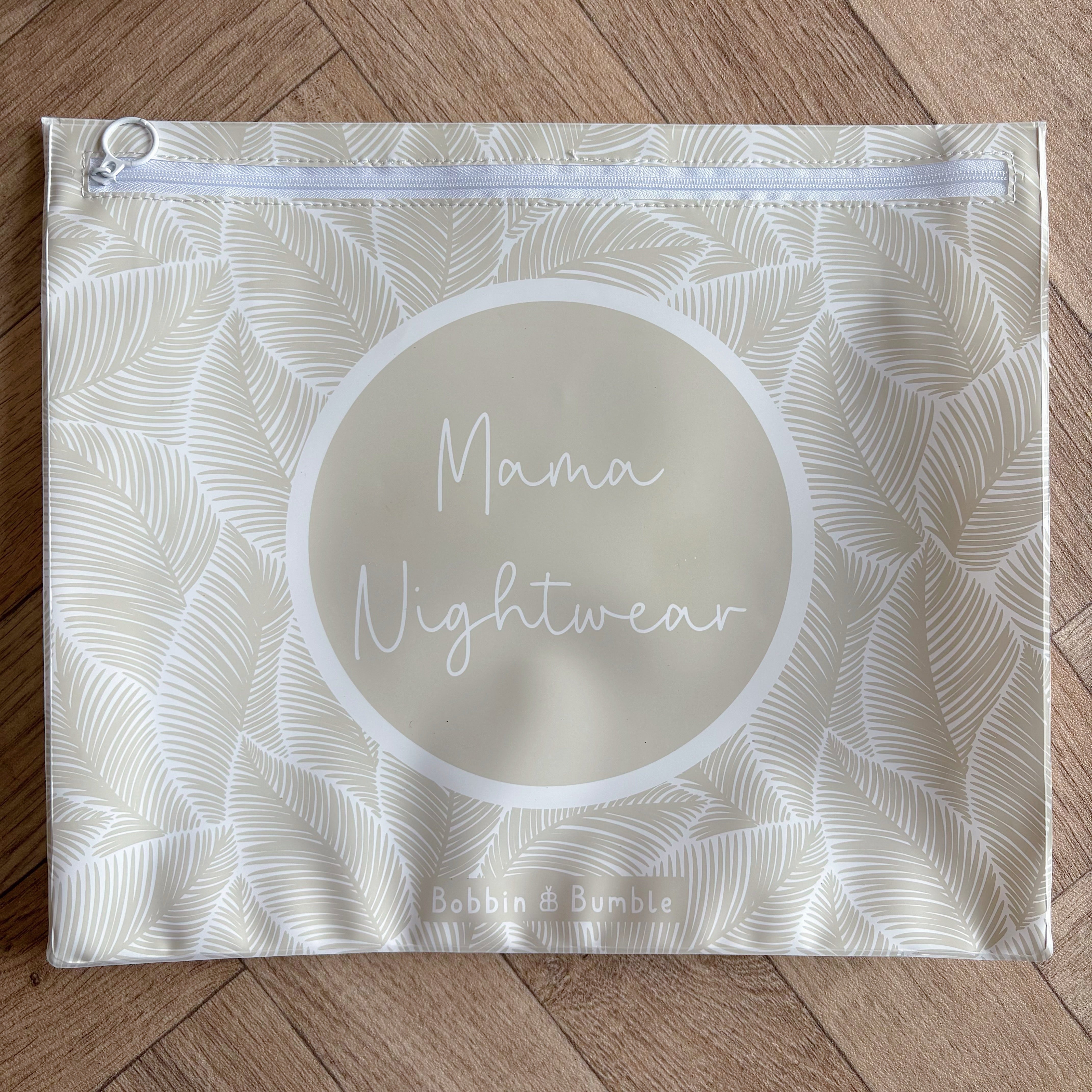 Hospital bag organiser pouches, beige leaf, flat pouch labelled Mama Nightwear on a wooden floor