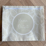 Hospital bag organiser pouches, beige leaf, flat pouch labelled Mama Outfit on a wooden floor