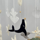 Ocean Whispers felt cot mobile close up of the navy whale, grey stingray, starfish, coral and turtle hanging below the ring