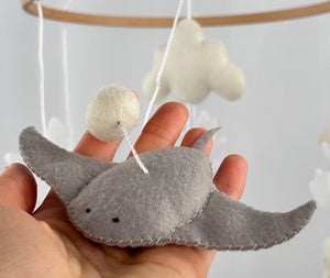 Ocean Whispers felt cot mobile detail of the grey felt stingray with a felt ball above, resting on a hand