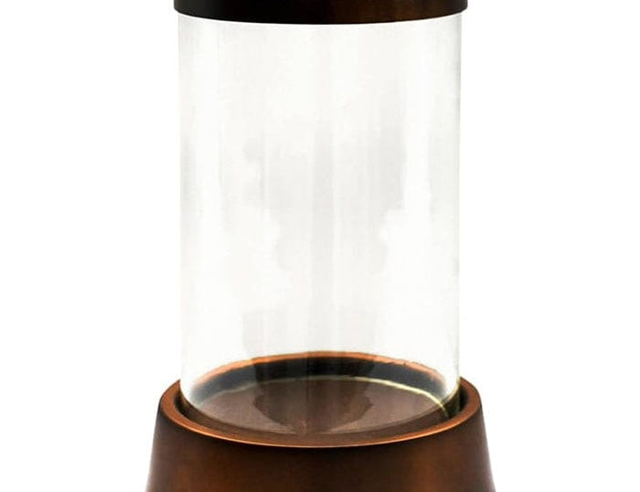 Palm Beach Hurricane Lantern with a clear glass cylinder and a copper-toned base and rim, on white