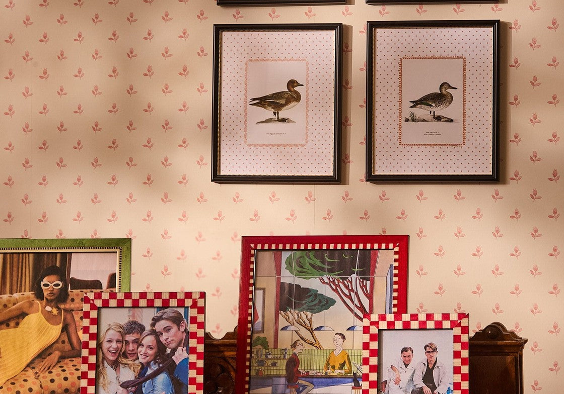 Classic Red Checked Photo Frame 7x5 displayed with other frames on a carved wooden table below framed duck prints
