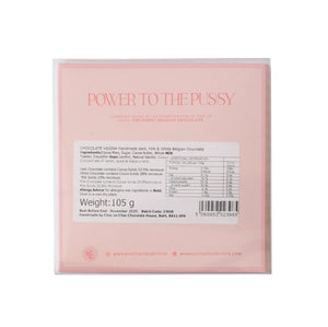 A square pink package of 'Power to the Pussy' chocolate from Bruges Chocolate Company, featuring a white nutrition label on the front against a white background.