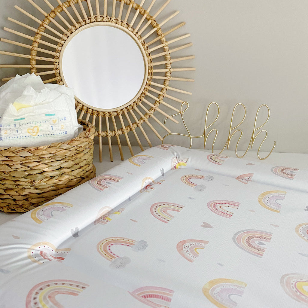 Standard Changing Mat Beau Rainbow Print in a nursery setting with a nappy basket, rattan mirror and gold Shhh wire sign