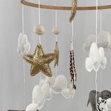 Safari Dreams Felt Cot Mobile side angle showing the rhino, gold star, clouds, giraffe and zebra hanging from the ring