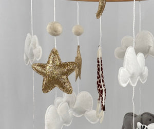 Safari Dreams Felt Cot Mobile side angle showing the rhino, gold star, clouds, giraffe and zebra hanging from the ring