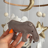 Safari Dreams Felt Cot Mobile with a hand holding the grey-brown felt rhino with stitched edges