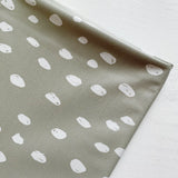 Splash Mat Sage Spots, angled close-up of the folded edge and the white spot print