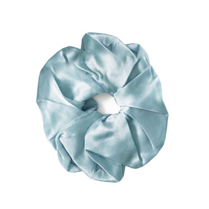 A single light blue satin hair scrunchie on a solid white background.