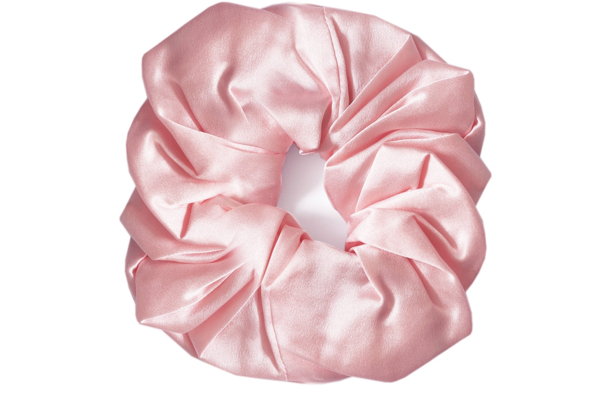 A single light pink satin hair scrunchie centered on a plain white background.
