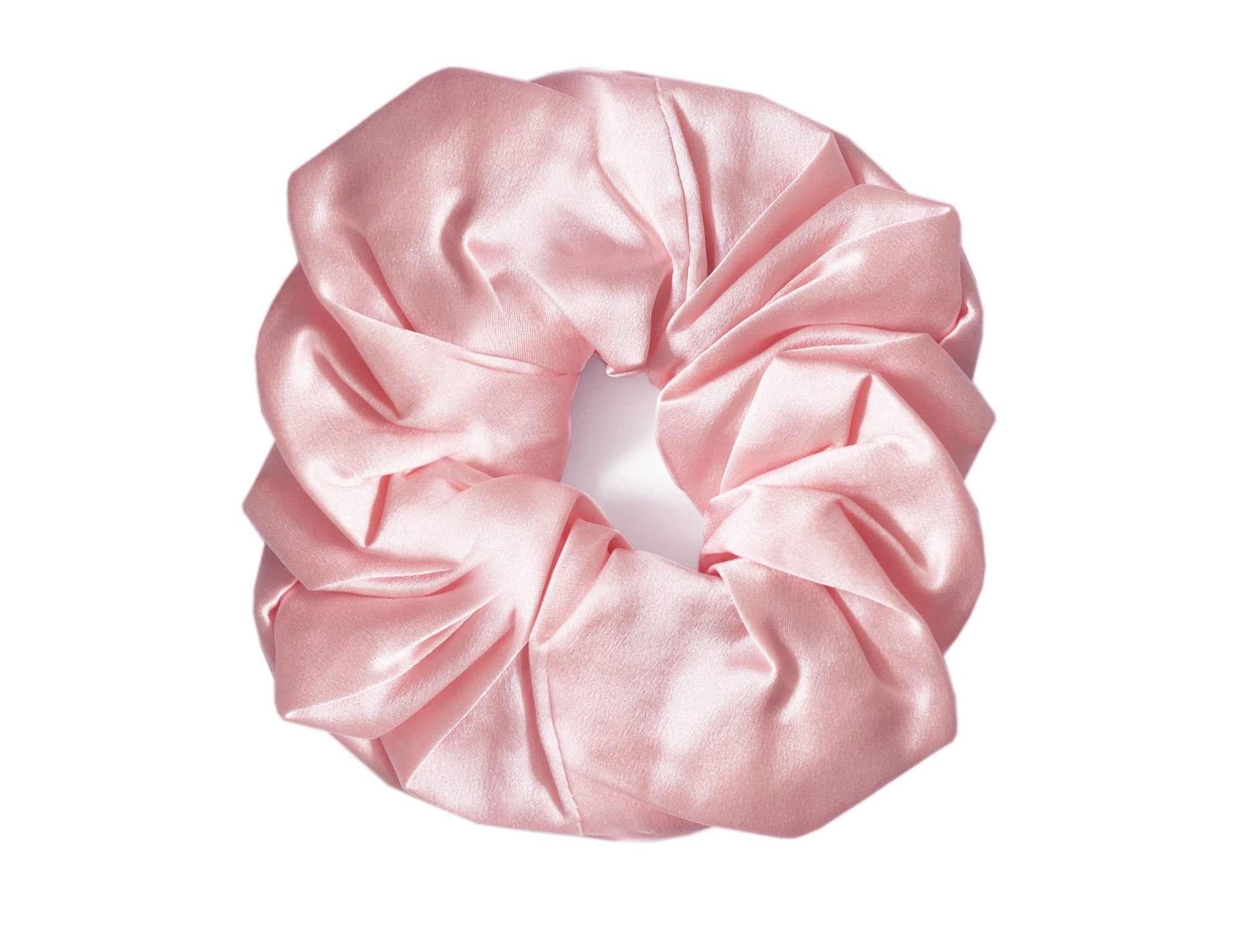 A single light pink satin hair scrunchie centered on a plain white background.