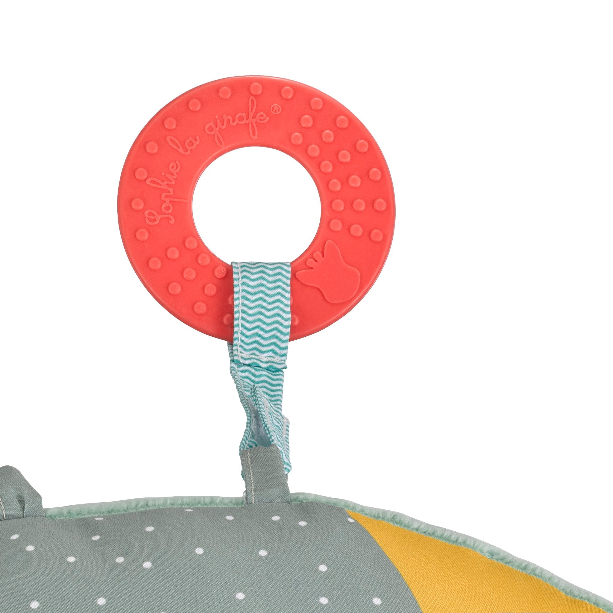 Sophie la girafe Cosy Play Cushion, close-up of the red textured teething ring on a zigzag strap
