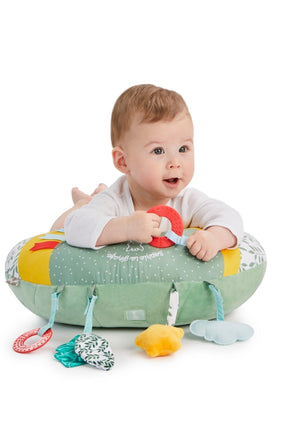 Sophie la girafe Cosy Play Cushion, baby lying on tummy over the cushion holding the red ring toy