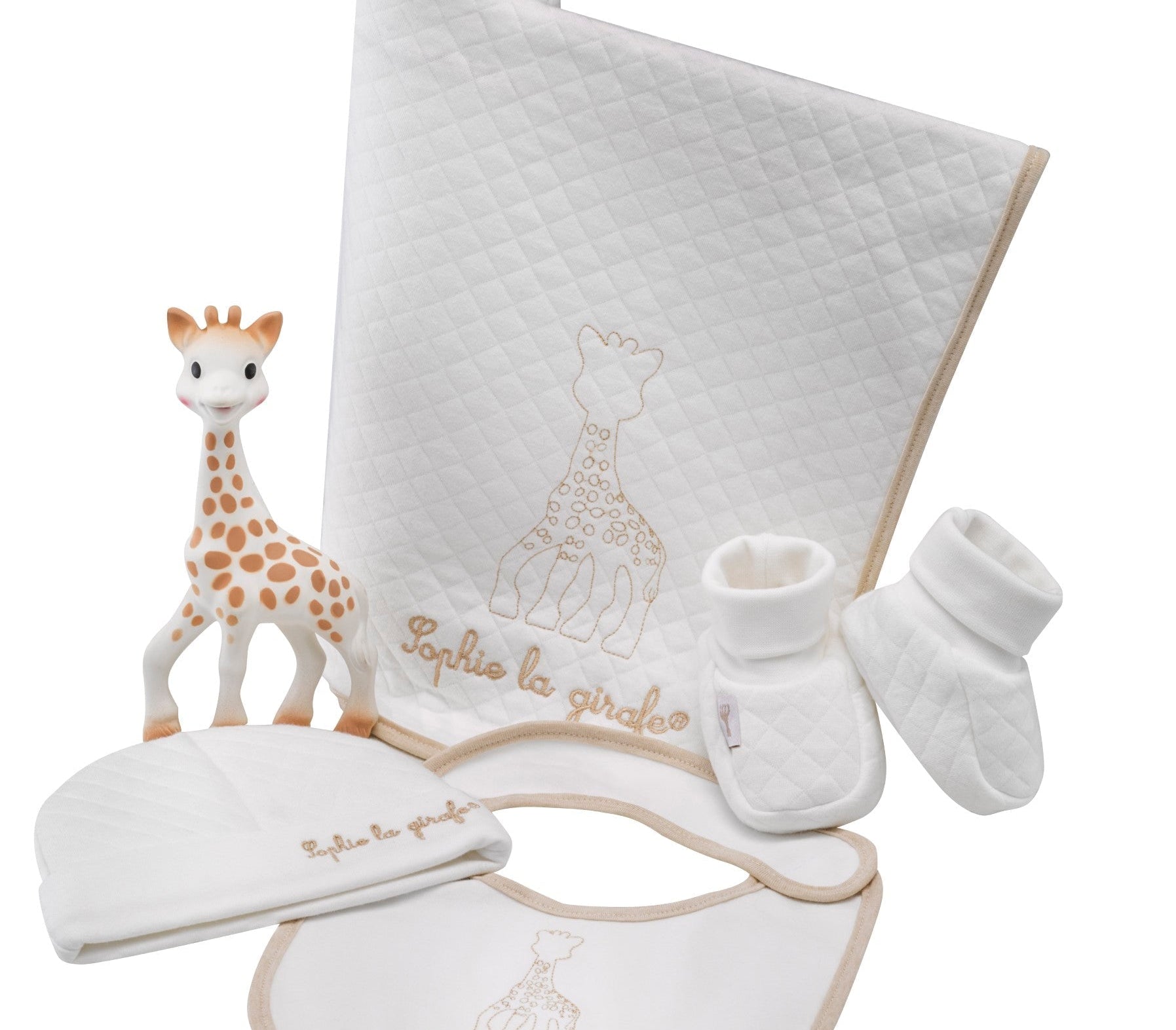 Sophie la girafe My Birth Outfit Gift Set laid out: giraffe toy, quilted blanket, hat, bib and booties