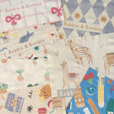 Splash mats in a range of prints laid out together, including pink bow, llamas, Pot Plants and stationery