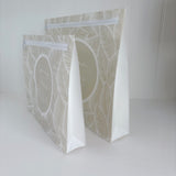 Hospital bag organiser pouches, beige leaf, side view of two standing pouches showing the white expanding side gusset