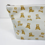 Teddy Bear Print nappy wallet, close-up of the teddy bear print, some bears wearing patterned tops, with zip at top