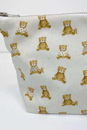 Teddy Bear Print nappy wallet, close-up of the teddy bear print, some bears wearing patterned tops, with zip at top