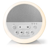 Yogasleep Nod white noise sound machine glowing with its soft amber night light