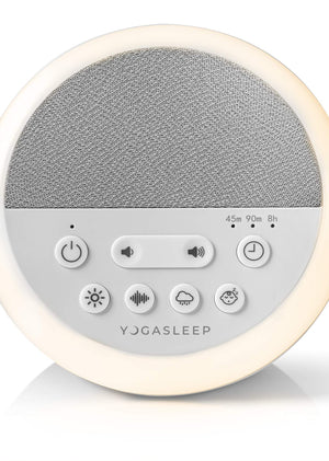 Yogasleep Nod white noise sound machine glowing with its soft amber night light