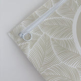 Hospital bag organiser pouches, beige leaf, close-up of the white zip and ring pull in the corner of a pouch