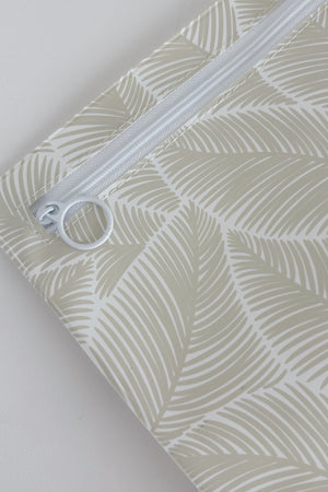Hospital bag organiser pouches, beige leaf, close-up of the white zip and ring pull in the corner of a pouch