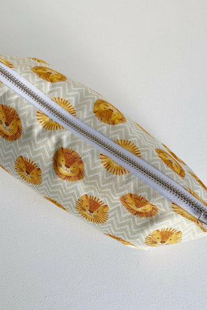 Nappy wallet in Leo lion print, top-down view of the closed pouch lying flat showing the long silver zip
